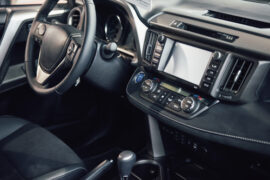 Luxury car Interior - steering wheel, shift lever, dashboard and computer.